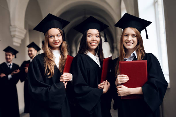 istock Three girls are posing for a camera at the university. 910493882