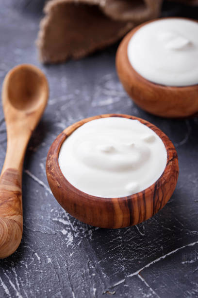 istock White Greek yogurt in wooden bowl 910494332