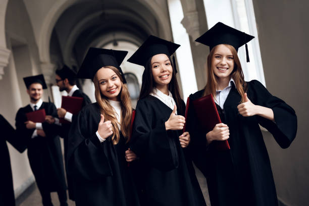 istock Three girls are posing for a camera at the university. 910495766