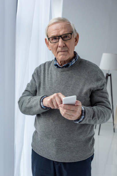 istock Senior confident man in eyeglasses using smartphone 910496820