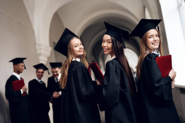 istock Three girls are posing for a camera at the university. 910498990