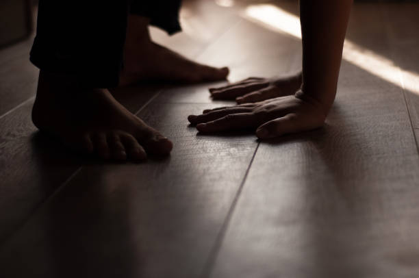 istock Woman's legs on a warm wooden floor 910499722