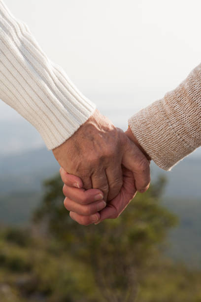 istock senior hands embraced in the countryside 910500146