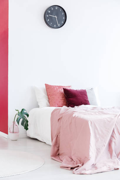 istock Pink and white bedroom interior 910503598