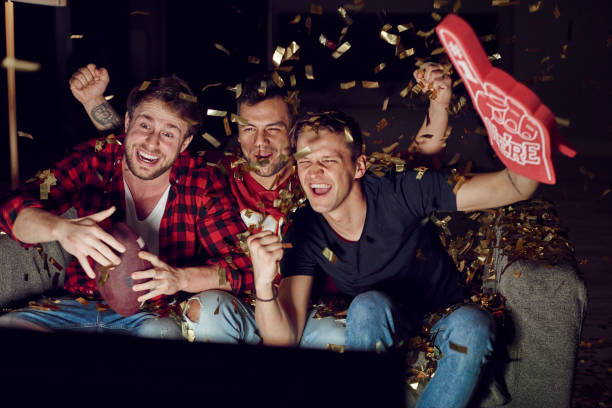 istock Sport fan cheering among confetti falling 910511548