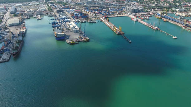 istock Industrial seaport, top view. Port cranes and cargo ships and barges. 910516340
