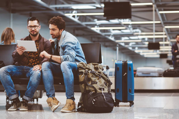 istock Travelers waiting in airport terminal 910520348