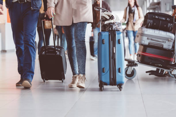 istock Group of people walking with suitcase at airport terminal 910520608