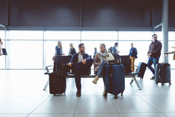 istock People in international airport waiting for flight 910523994