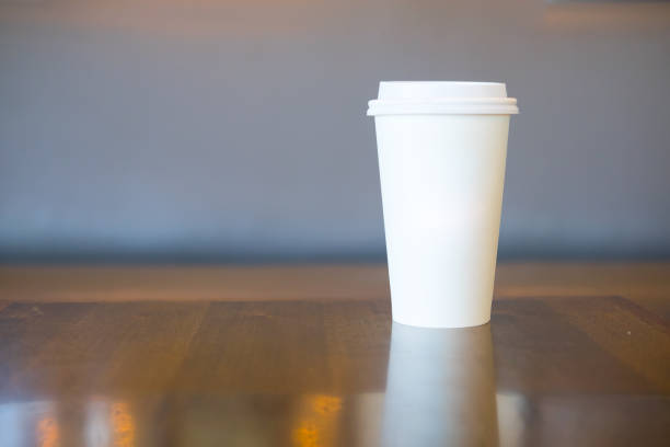 istock White paper cup for hot coffee or tea on wood table 910524502