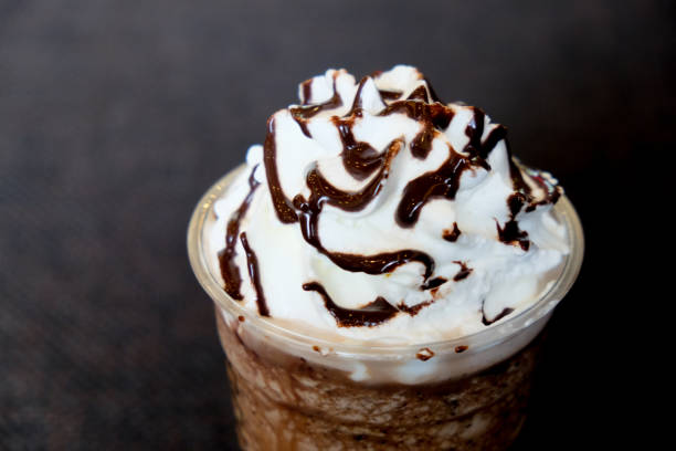istock Whipped cream on top chocolate frappe and chocolate sauce  (Close up) 910524774