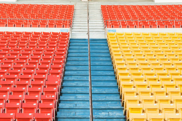 istock Empty orange and yellow seats at stadium 910524872