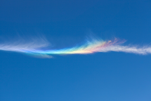 A fire rainbow, is an optical phenomenon that belongs to the family of ice halos formed by the refraction of sun- or moonlight in plate-shaped ice crystals suspended in the atmosphere, typically in cirrus or cirrostratus clouds.