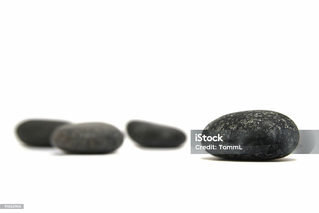 some round granit stones some round granit stones isolated on white background Balance Stock Photo