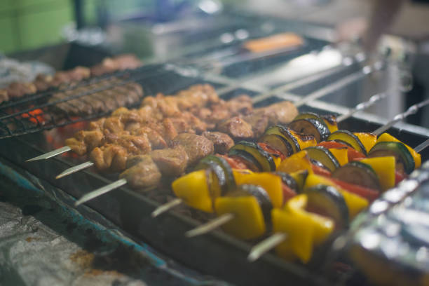 istock Marinated shashlik or Shish kebab preparing on a barbecue grill over charcoal. 910539402