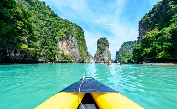 Tourist are visiting by flatwater canoeing Tourist are visiting by flatwater canoeing. Located in Ao Phang Nga National Park, Phuket, Thailand. rafting kayak kayaking river stock pictures, royalty-free photos & images