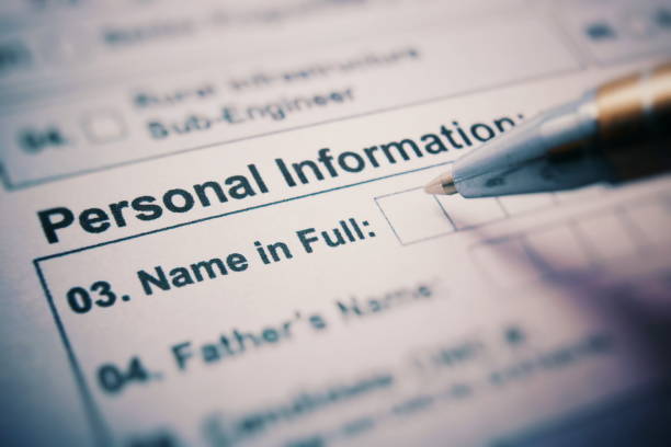 NAME IN FULL on a printed form close up. pen in hand writes