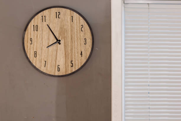 istock Five minutes to eight o clock on the dial round wall clock 910546690