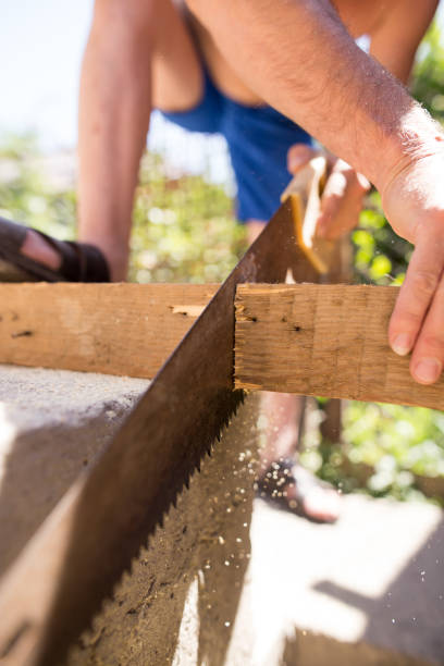 istock A man is sawing a beam of wood 910547332