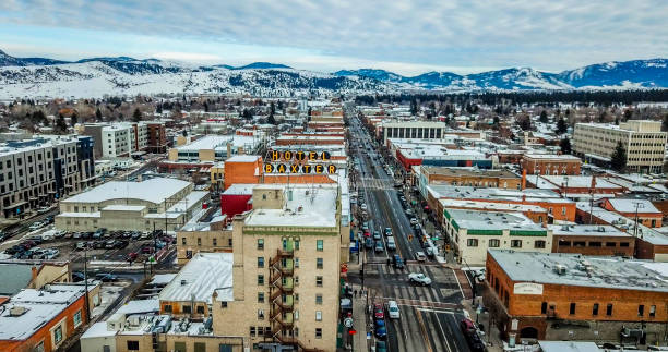 Aerial View of Downtown Bozeman with Baxter Hotel Aerial View of Main Street in downtown Bozeman Montana. Winter snow is scattered on streets and buildings with the mountain range covered in snow in the distance. Famous Baxter Hotel Sign is seen up close. montana western usa photos stock pictures, royalty-free photos & images