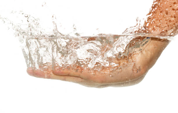 istock hand in water isolated on white background 910551420
