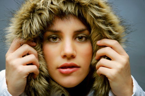 Young woman in a winter fur hood.