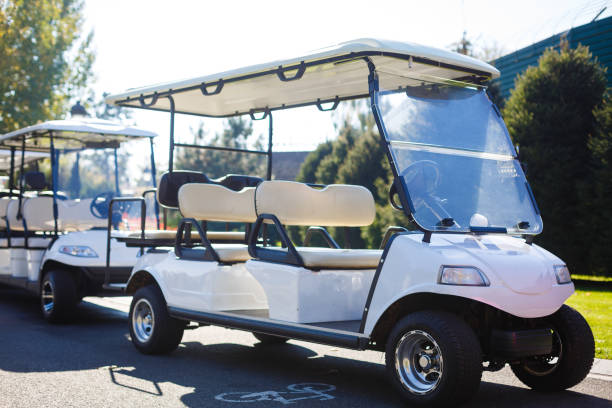 istock Golf cart over nice green and blue sky 910556222