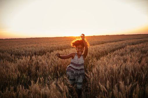 Little girl running in the field