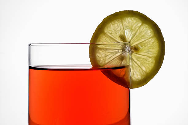 Glass of red liquid (wine,  tea, etc.) stock photo