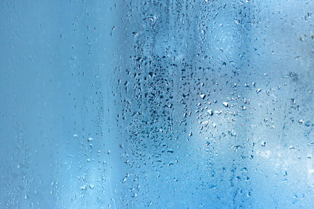 istock Natural water steam on glass. Blue drop texture 910560580