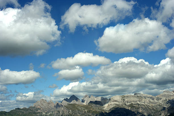 Monte Civetta mountain in the Dolomites surrounded by clouds during sunset after a beautiful springtime day. The Civetta is a prominent and major mountain of the Dolomites, and is popular amongst mountaneers to climb as its one of the highest rock formations in Europe.