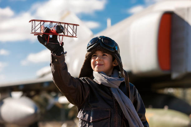 istock Boy playing with toy airplane 910568034