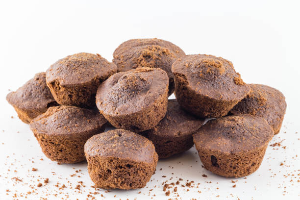 istock Cupcakes. Chocolate muffins fresh home baked on white background 910575830