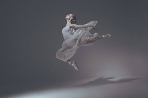 istock beautiful elegant ballet dancer jumping in white dress 910577892