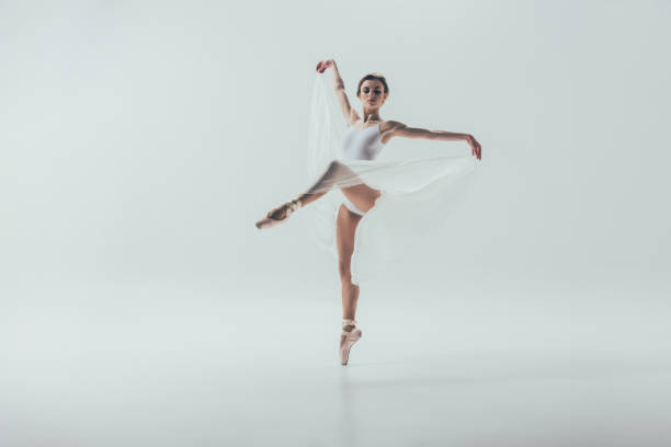 istock young elegant ballerina dancing in studio, isolated on white 910578460
