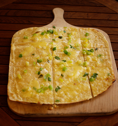 Healthy breakfast. Omelet with green peas, feta cheese and dill. Dark background.
