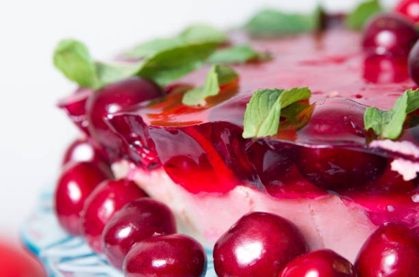 istock Birthday cake with cherries closeup 910581200