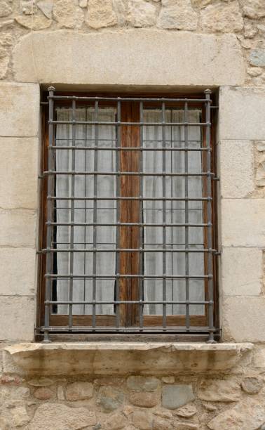 istock Wooden window on stone wall 910582556