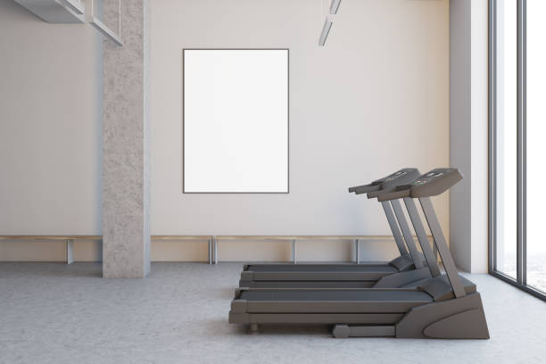 istock Two treadmills in a white room, close up side 910585060