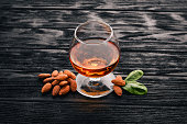 Amaretto Almond Liquor. Almond On a wooden background. Italian drink Top view. Free space for text.