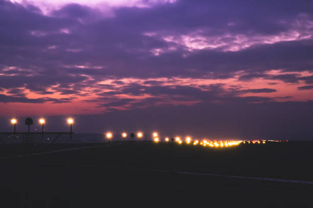 Runway Lighting Systems  in sunsed  bakground, red and purple fantastic dramatic skies