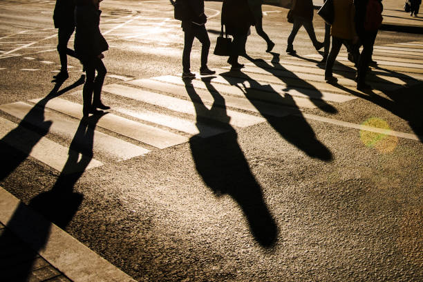 istock Blurry people and their shadows on crossing 910593722