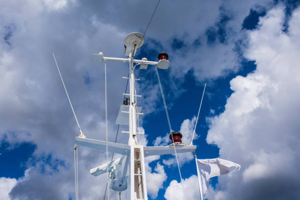 Ships antenna and navigation system on a blue and cloudy sky background