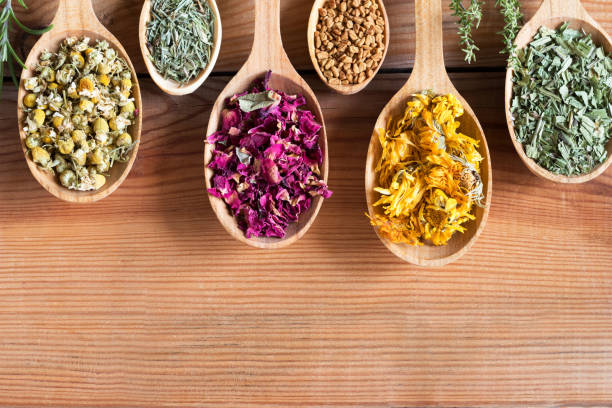 istock Dried herbs on spoons on a wooden background with copy space 910599324