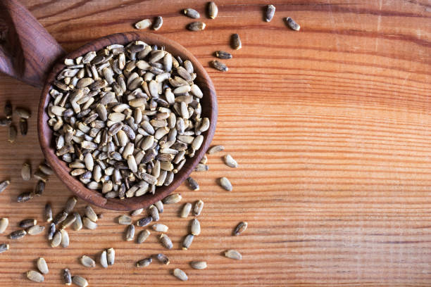 istock Milk thistle seeds on a wooden spoon with copy space 910599350