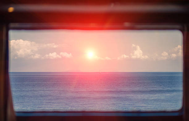 istock view through the captain's window on ocean and boath on sunset 910600018