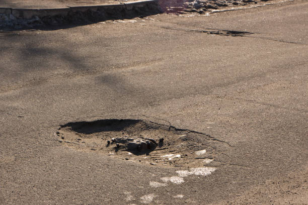 istock there are many potholes on the roadway close up 910600160