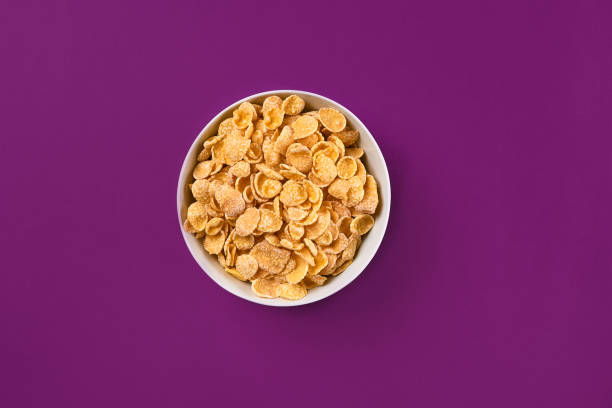 istock Bowl with cornflakes on the colorful background 910609854