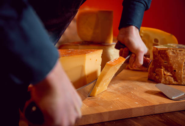 istock Cut with a knife piece of cheese 910626168