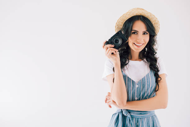 istock smiling woman with photo camera 910633588